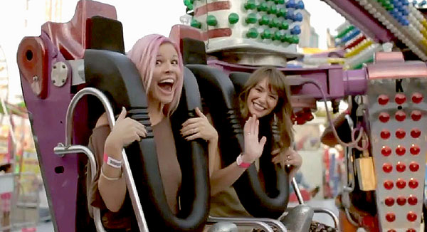 Two girls on a carnival ride.