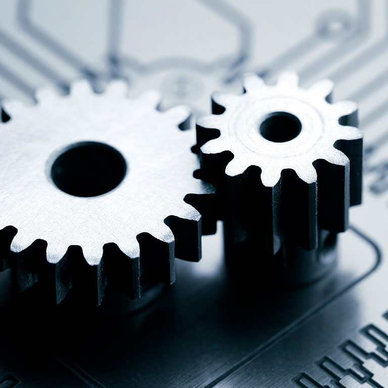 Close up of gears Turing on circuit board