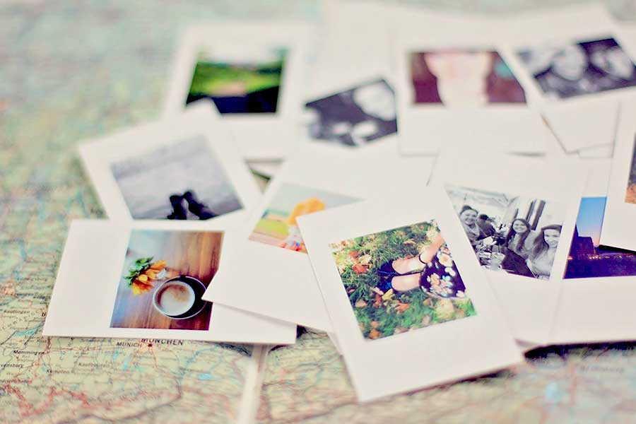 Polaroid photos spread out over a map.