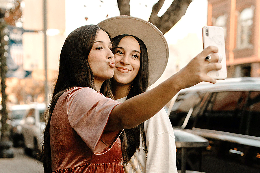 Two female besties taking a selfie together