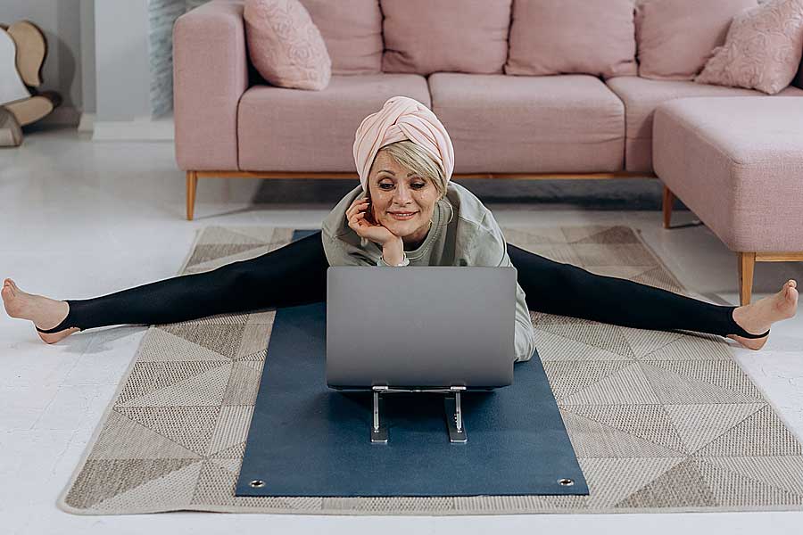 Senior living personas yoga woman in front of computer