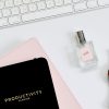 clean desk with Apple keyword, watch, perfume or cologne and productivity journal