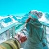 Couple holding hands on a snowy peak