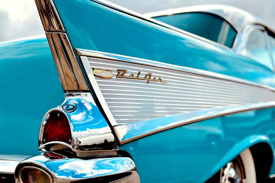 Side view of Chevy BelAir logo on side of teal car